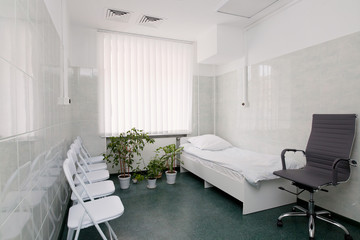 Wall Mural - clean and comfortable room for patient in the hospital .  hospital ward with bed, window and chairs for visitors close up. doctor's room close up. hospital check-ins 