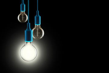 Wall Mural - Idea and teamwork concept - Vintage incandescent bulbs on black background