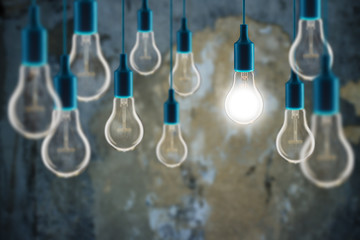 Wall Mural - Idea and teamwork concept - Vintage incandescent bulbs on the grunge background