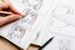 © Sensay - Artist drawing an anime comic book in a studio.