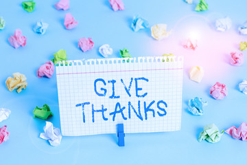 Wall Mural - Conceptual hand writing showing Give Thanks. Concept meaning express gratitude or show appreciation Acknowledge the kindness Colored crumpled papers empty reminder blue floor clothespin