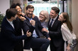 Happy diverse colleagues have fun celebrate success or victory in office, excited multiracial employees coworkers feel overjoyed euphoric triumph win business project together, leadership concept