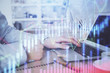 © peshkova - Multi exposure of stock market chart with man working on computer on background. Concept of financial analysis.