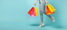 Beautiful Young Woman And Shopping Bags On Blue Background