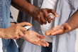 Unrecognizable Black Man And Woman Applying Disinfectant Spray On Hands, Closeup