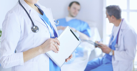 Female doctor using tablet computer in hospital lobby