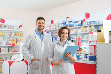 Portrait Of Professional Pharmacists In Modern Drugstore