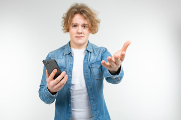 confused guy with a phone in his hand isolated on a white background