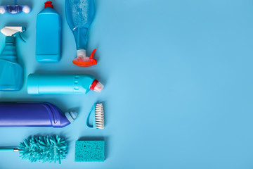 Many cleaning products on blue background. Top view