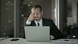 © stockbakers - The Tired Businessman having Nap at Office table at Night
