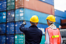 Warehouse Shipping Transportation Concept. Commercial Docks Worker And Inspector At Commercial Dock. Workers Are Wearing Protective Clothing They Are Standing Against Cargo Containers.