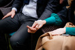 © kavoons - cropped shot of woman and man holding hands sitting on the sofa