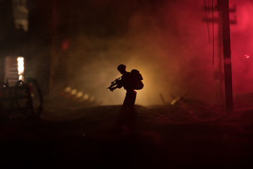 War Concept. Military silhouettes fighting scene on war fog sky background, World War Soldiers Silhouette Below Cloudy Skyline At night.