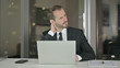 © stockbakers - The Tired Young Businessman having Neck Pain at Night