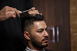© AJ_stock_photos - the guy is a dark-haired Asian Indian appearance on a haircut in a barbershop . cinematic image