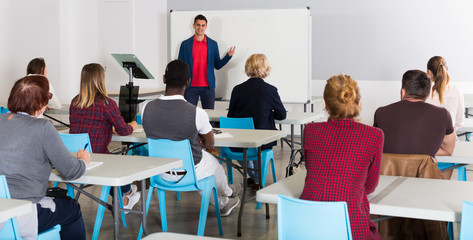 Wall Mural - Male teacher giving presentation for students