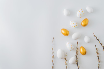 Wall Mural - flat lay easter composition with a willow branch and eggs on a white background