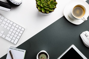 Cup of coffee with office tools on black and white background, office flat lay