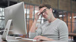 © stockbakers - Tired Guy having Headache while Working on Desktop