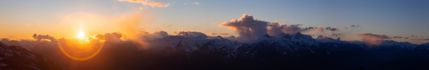 Wall Mural - Beautiful Dramatic Canadian Mountain Landscape View during a sunny and cloudy winter sunset. Taken in Squamish, British Columbia, Canada. Nature Background Panorama