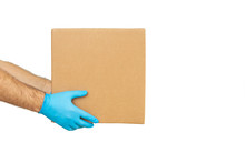 Delivery Man Holding Cardboard Boxes In Rubber Gloves / Copy Space. Fast And Free Delivery Transport . Online Shopping And Express Delivery 