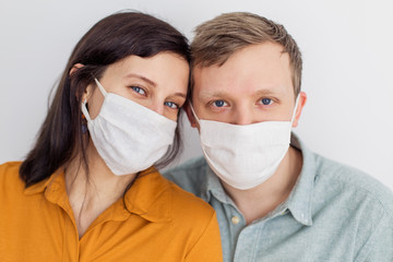 Two young men with blue eyes in a mask from a coronavirus. Positive young people are protected from covid-19. Smile and love quarantined