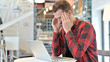 © stockbakers - Beard Young Man with Headache using Laptop in Cafe