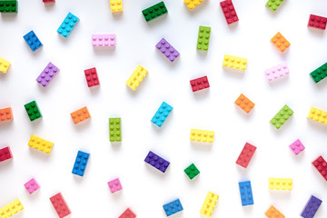 Colored toy bricks on white background