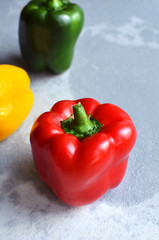 Red fresh bell pepper with multi-colored sweet peppers. Green, red and yellow vegetables. Healthy food concept