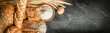Bread with wheat and bowl of flour on dark board, White bakery food concept panorama or wide banner photo.
