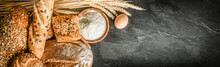 Bread With Wheat And Bowl Of Flour On Dark Board, White Bakery Food Concept Panorama Or Wide Banner Photo.