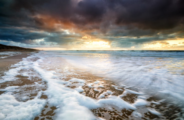 dramatic sunset on north sea during storm