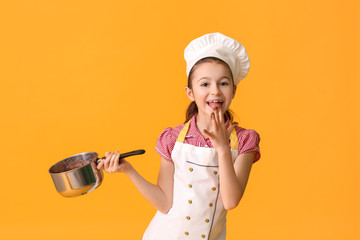 Poster - Little housewife with melted chocolate in saucepan on color background