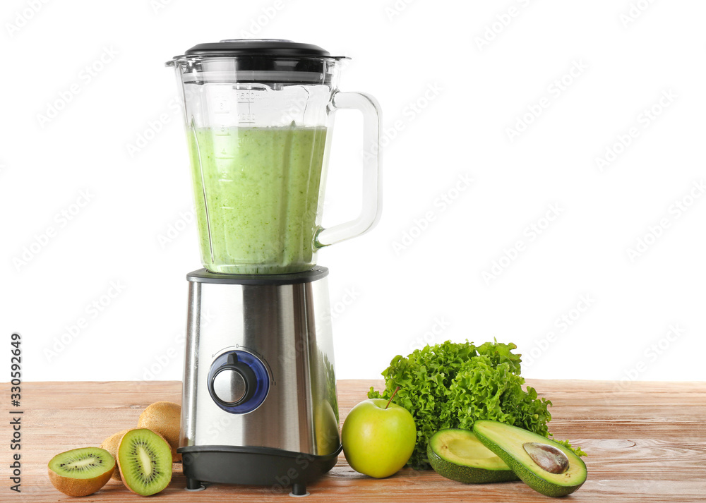 Blender with ingredients for healthy smoothie on table against white background