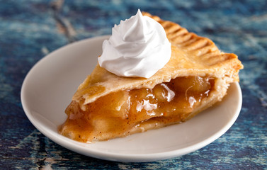 Slice of Homemade Apple Pie on a Rustic Wooden Table