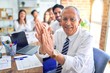 © Krakenimages.com - Group of business workers smiling happy and confident. Working together with smile on face looking at the camera applauding at the office