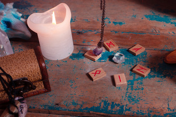 Fortune telling with a pendulum and runes