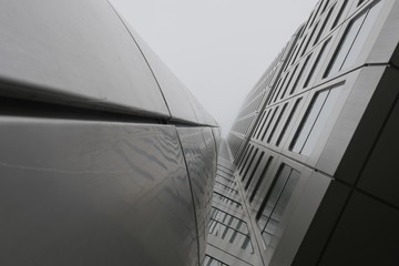 Wall Mural - Low angle shot of a skyscraper under a clouded sky