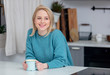 blonde lady with cup of coffee at kitchen