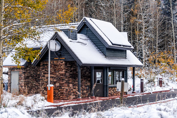 Wall Mural - Maroon Bells entrance building fee in white river national forest in Aspen, Colorado USA rocky mountain covered in snow after winter frozen in autumn