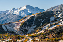 Aspen, Colorado Buttermilk Or Highlands Famous Ski Slope Hill Peak In Rocky Mountains View On Sunny Day With Snow On Yellow Foliage Autumn Trees