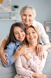© Pixel-Shot - Mature woman with her adult daughter and mother spending time together at home