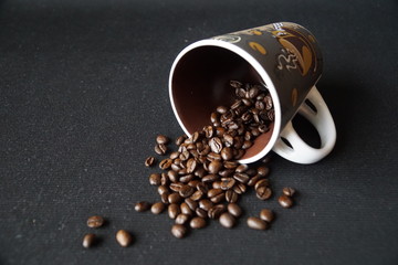 roasted coffee beans in a lying cup