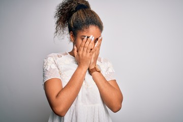 Sticker - Young beautiful african american girl wearing casual t-shirt standing over white background with sad expression covering face with hands while crying. Depression concept.