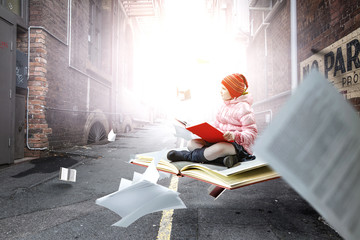 Little girl reading a book