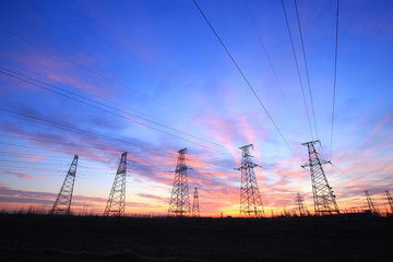 In the evening, the high voltage tower and the beautiful sunset glow