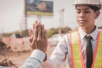 Businessman two people shake hand success at construction site partnership community