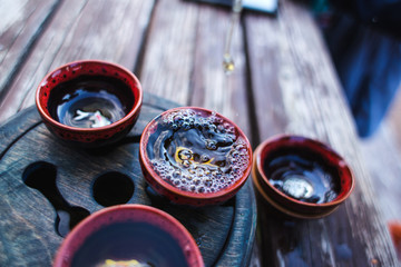 Tea pours from a teapot into a cup, tea ceremony.