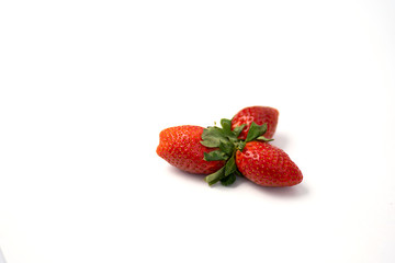 Red and fresh strawberries isolated on white