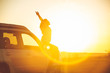 © phpetrunina14 - woman stop at roadside to enjoy sunset. sitting on car hood
